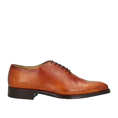 Tan leather shoe on a white background